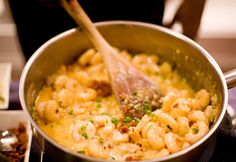 a pan filled with macaroni and cheese on top of a stove