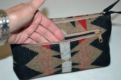 "An amazing little Pendleton® wristlet A vintage item Excellent condition - looks brand new - the corners and the interior show no signs of wear Beautiful khaki, red, black and beige Native American design. Could be useful in so many ways; cosmetic bag, sunglasses pouch, wallet, purse organizer. The possibilities are endless! Could be a young girls first purse! Top zipper. Fabric handle is attached to the zipper pull, so when unzipped it makes a nice handle to hold the bag as you reach inside. S Pendleton Cosmetics Bag, Pendleton Bag, Sunglasses Pouch, Sun Glass, Purse Organizer, Native American Design, Cell Phone Wallet, Girls Purse, Purse Organization