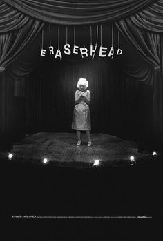 a black and white photo of a woman standing on stage with the words erasehead above her head