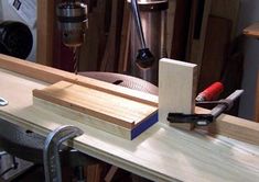 a workbench with tools on it and some woodworking equipment in the background