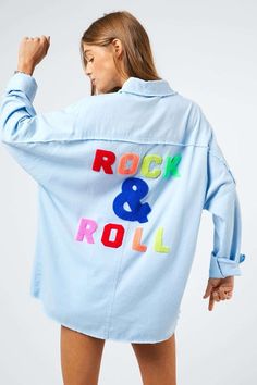 Rock & Roll Fringed Hem Shirt This shirt features multi color letters and a fringed hem detail, creating a stylish and unique look. The combination of the colorful letters and the distinctive fringed hem adds a touch of individuality to the design. It's a versatile piece that can be a standout addition to your wardrobe. Details: Color: Blue or White Multi Color Embroidered Logo Long Sleeves Frayed Hem Collared Button Down Oversized Non-Stretch Non-Sheer Model is wearing size small Fit: True to S Roll Logo, Printed Letters, Wardrobe Style, Rock Roll, Sheer Fabrics, Stylish Shirts, Collar Shirts, Rock And Roll, Denim Button Up