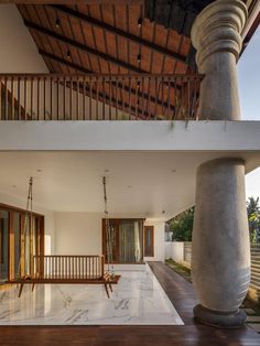 the inside of a house that is very large and has a porch with swings on it