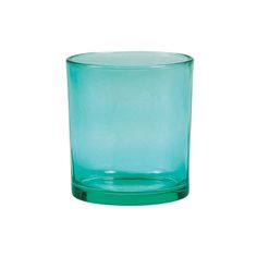 a green glass sitting on top of a white surface