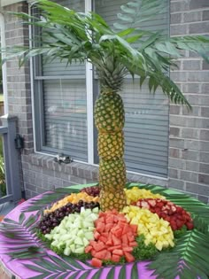 a pineapple palm tree surrounded by fruits and vegetables