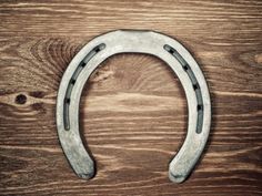 a metal horseshoe on top of a wooden table