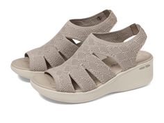 PRICES MAY VARY. 2 inch wedge sandal with a crochet cut out knit upper Luxe Foam cushioned comfort footbed Shock-absorbing midsole Machine washable Crafted with 100% vegan materials Casual Beige Wedge Sandals With Arch Support, Comfortable Beige Wedge Sandals With Arch Support, Skechers Shoes Women, Taupe Shoes, Memory Maker, Sandal Platform, Skechers Women, Fashion Toys, Skechers Shoes