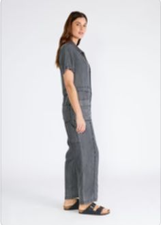 A classic utility-style jumpsuit in an ash grey wash tencel. Tencel Relaxed fit Short sleeve Long straight leg Collared neckline Button front top Zip fly closure Front patch pockets Back patch pocket Utility jumpsuit A jumpsuit to wear on repeat all spring and summer long. Featuring the perfect relaxed fit, our utility-style one-piece is crafted from lightweight tencel and features a button-front top and collared neckline. Short sleeves keep things breezy, while the straight long leg pairs well Utility Jumpsuit, Hair Socks, Style Jumpsuit, Casual Bodysuit, Sparkle Top, Utility Style, Overalls Pants, Button Front Top, Baby Pajamas