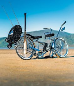 two bikes are parked on the beach with fishing rods attached to them and one is upside down