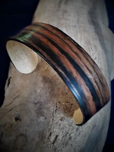 "This stable and flexible bracelet is an ornament for every wrist. The base of flexible spruce wood and a unique layer of Alpi Makassar venner already promises a long life. The top layer is a laquer approved for children's toys  (norm DIN EN 71 ). Please note that every order is a custom order. It is the nature of the material that every cuff will have its own unique appearance. Also important to know is, that all veneers from \"Alpi\" and \"SaRaiFo\" (Save the Rainforest)  are only replicas of real rainforest wood, to help preserve the important habitats of the rainforest. Thank you for visiting my shop. Please let me know if there is anything I can help you with. Stefan Leifeld LivoltArts" Natural Bangle Bracelets As Gift, Natural Bangle Bracelets For Gifts, Natural Color Bangle Bracelets As Gift, Adjustable Wood Bracelets As Gifts, Adjustable Wooden Bracelets As Gifts, Natural Wood Bracelet Jewelry Gift, Natural Wood Bracelet As A Gift, Handmade Natural Wood Bracelets As Gift, Handmade Natural Wood Bracelets For Gift