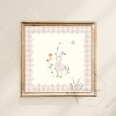 a white duck and some flowers in a wooden frame on a wall above a plant