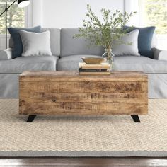 a living room with a couch, coffee table and books on top of the table