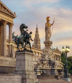 a statue in front of a large building