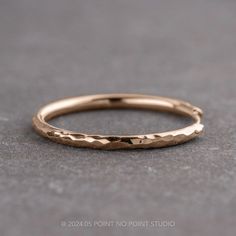 a close up view of a gold wedding ring on a gray surface with the words,