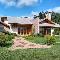 a large house sitting on top of a lush green field