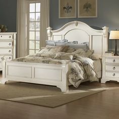 a bedroom with blue walls and white furniture