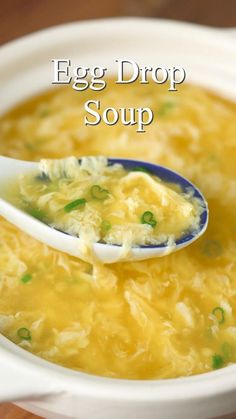 an egg drop soup in a white bowl with a spoon