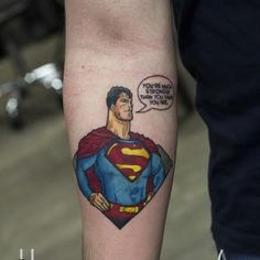 a man's arm with a superman tattoo on it and a comic bubble above his head