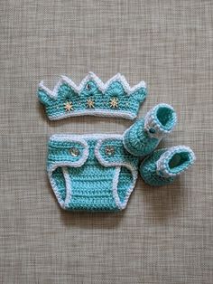 a crocheted baby outfit and booties on a table