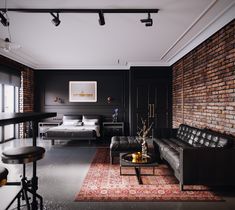 a living room filled with furniture and brick walls