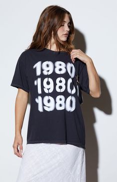 The 1980 Blur Oversized T-Shirt from PS / LA offers a bold, relaxed style with its short sleeves and crew neckline. The shirt features a striking 1980 blurred graphic and comes in an oversized fit for a laid-back look.Solid color teeShort sleevesCrew necklineFront graphicOversized fitOne size fits mostFits like a women's size XL100% cottonMachine washableModel measurements: 5’6.5” height, 32” bust, 23.5” waist, 35” hip PS / LA Womens 1980 Blur Oversized T-Shirt - Black Summer Graphic Print Washed Black T-shirt, Summer Washed Black Graphic Top, Retro Washed Black T-shirt For Summer, Women's Graphic Tees, Comfy Sweatpants, Baby Fits, Top Graphic Tees, T-shirts & Tank Tops, Oversized T Shirt