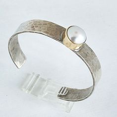 Please allow 3-5 weeks for this to be custom made and ship Sterling silver cuff with 14kt gold bezel and 1 Mother of Pearl Designed by Richard Schmidt Modern Hammered Cuff Jewelry, Classic Hammered Adjustable Jewelry, Classic Adjustable Hammered Jewelry, Adjustable Hammered Cuff Bracelet For Anniversary, Pearl Cuff, Hammered Sterling Silver, Pearl Design, Sterling Silver Cuff, Silver Cuff