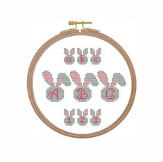 a cross stitch pattern with bunny ears and the number six on it's side