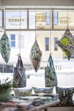 hanging fabric bags in the window of a store