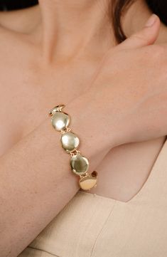 This pebble-inspired bracelet features a high-polish finish that catches light with your every gesture. 7" length; 2" extender Lobster clasp closure 18k-gold plate or rhodium plate Imported Hammered Metal Bracelets For Formal Occasions, Hammered Metal Bracelet For Formal Occasions, Formal Hammered Metal Bracelets, Modern Gold Oyster Bracelet, Linked Bracelet, Bachelorette Party Dress, Denim Jean Dress, Polished Pebble, Bracelet Shop