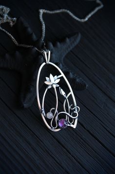 The size H 4 cm x W 3 cm (1 3/4 x 1 inch). Weight - 6g. You can buy it with the chain or without. The most delicate flower of the lotus can make someone very happy. I made this botanical jewelry of sterling silver, amethyst, and peach moonstone. This is a true work of art. It will emphasize your exquisite taste and status, and will also bring a lot of compliments. Lotus flower earrings https://www.etsy.com/listing/676137548/lotus-flower-earrings-sterling-silver?ref=shop_home_active_2&frs=1 O Elegant Wire Wrapped Jewelry For Meditation, Amethyst Amulet Jewelry For Gifts, Amethyst Amulet Jewelry As Gift, Hand Forged Flower Pendant Necklace As Gift, Wire Wrapped Flower Pendant Jewelry Gift, Handmade Spiritual Jewelry With Flower Pendant, Artistic Silver Wire Wrapped Necklaces, Artistic Silver Wire Wrapped Necklace, Handmade Teardrop Pendant Jewelry For Wedding