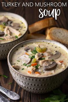 two bowls of turkey and mushroom soup on a wooden table with spoons next to it