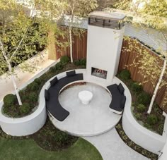 an outdoor living area with seating and trees in the back yard is shown from above