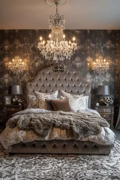 a bedroom with a bed, chandelier and pillows