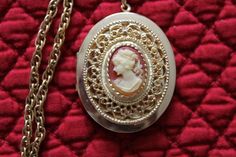 This vintage locket has a very pretty cameo.   It measures  46 mm x 38 mm.        I put this gorgeous locket on  a wonderful 22 1/8 inch gold plated  vintage rope chain.  I added a gold plated bail to the cameo and a gold plated toggle to finish the necklace.  This locket has a little wear on the back, but otherwise is in great vintage condition.  The chain is also in excellent vintage condition.  Together they make a beautiful necklace.   This necklace would make a lovely gift for any woman who wants to carry the photos of her loved ones next to her heart. Thank you for taking time out of your day to visit  KeepGrandmaBusy.  If you have any questions, please contact me through the etsy convo system. Evette Rice Cameo Medallion Locket Necklace, Vintage Locket Necklace For Valentine's Day Formal, Victorian Cameo Locket Necklace As A Gift, Cameo Medallion Necklace For Keepsake, Cameo Medallion Locket Necklace Keepsake, Cameo Medallion Locket Necklace For Keepsake, Victorian Locket Necklace With Vintage Charm As Gift, Keepsake Medallion Locket Necklace With Cameo, Cameo Medallion Jewelry For Anniversary