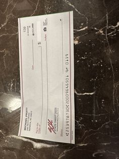 a check sitting on top of a marble counter