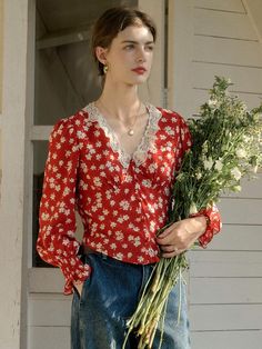 This product is a Floral V-Neck Red Blouse that beautifully combines vintage charm with contemporary fashion trends. It is designed with a flattering v-neckline framed by delicate lace, highlighting the décolletage area. The blouse’s long sleeves and relaxed fit contribute to its versatile nature, suitable for various occasions. - This blouse features a delightful floral pattern that exudes a sense of playful sophistication.- The lace detailing along the v-neck adds a refined touch, enhancing the overall design of the garment.- It's constructed with a lightweight fabric that offers both comfort and breathability.- Elasticated cuffs create a gentle puff effect on the sleeves, adding to the blouse's romantic and whimsical appeal. Feminine V-neck Top With Lace Collar, Elegant Red V-neck Blouse, Feminine Red V-neck Tops, Elegant V-neck Blouse With Lace Patchwork, Elegant V-neck Blouse With Lace Collar, Feminine V-neck Blouse With Lace Patchwork, V-neck Lace Blouse With Patchwork, Spring V-neck Blouse With Lace Collar, V-neck Lace Blouse With Lace Patchwork