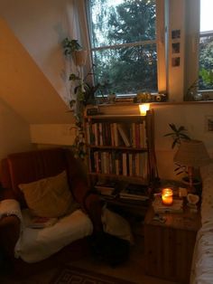 a living room with a couch, book shelf and window