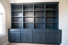 an empty bookcase in the corner of a room