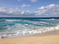 the ocean is blue and green with white clouds