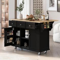 a kitchen island with drawers and shelves on wheels