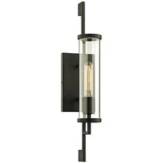 an outdoor wall light with a clear glass shade