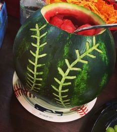 a watermelon shaped like a baseball and ball