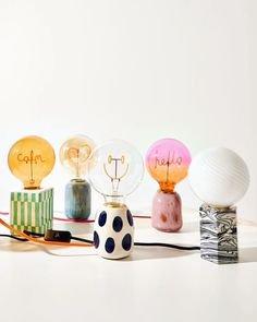 five different colored lamps sitting next to each other