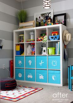 a child's room with striped walls and blue storage units, including a toy car