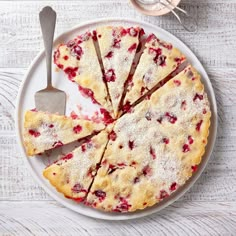 a white plate topped with slices of cake next to a fork and cup of coffee