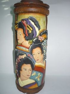 a vase with three women painted on it