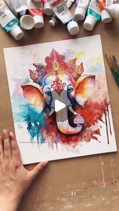 someone is painting an elephant with watercolors