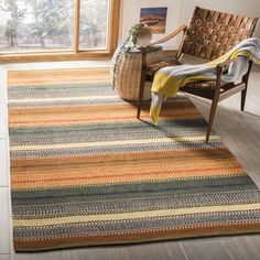 a living room with a chair and rug on the floor