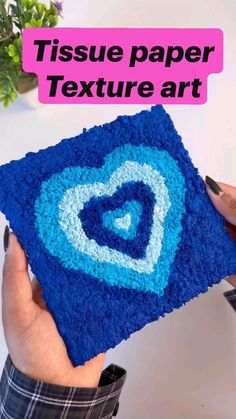 someone is holding up a blue square with a heart on it and the text tissue paper texture art