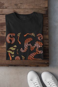 Mushrooms Shirt Printed on a super soft, cotton tee Dispatched in 5 working days or sooner Unisex Free UK delivery Material: 100% ringspun cotton. Chest (to fit): S  34/36   M  38   L  40/42   XL  44/46   XXL  48/50 ECO-FRIENDLY Each garment is made to order, reducing extra material and energy that would be otherwise wasted We use DTG printing process which is easier on the environment than screen-printing Our ink is bright and also eco-friendly. Do not tumble dry. Wash at 30 degrees c, inside o Black Y2k T-shirt With Custom Print, Black Crew Neck Fairy Grunge Top, Black Fairy Grunge Crew Neck Top, Y2k Black Custom Print T-shirt, Y2k Style Black T-shirt With Custom Print, Black Y2k Custom Print T-shirt, Black Y2k T-shirt For Fall, Black Y2k Style T-shirt For Fall, Black Fairy Grunge Top For Streetwear