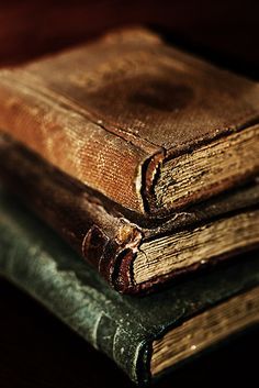 three old books stacked on top of each other